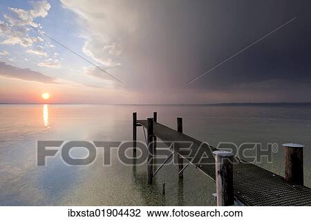"Jetty with evening light and stormy atmosphere overlooking Lake Constance near Bregenz, Rohrspitz, Austria, Europe" View Large Photo Image Stock Image - "Jetty with evening light and stormy atmosphere overlooking Lake Constance near Bregenz, Rohrspitz, Austria, Europe". Fotosearch