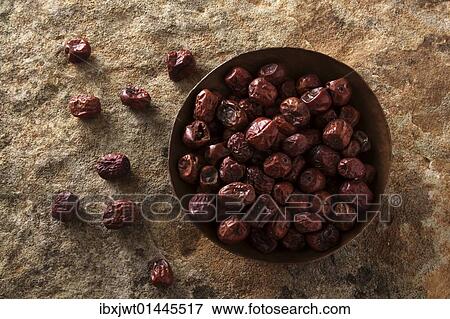 Jujube berries (Ziziphus jujuba) in a copper bowl on a stone surface View Large Photo Image Stock Photo - Jujube berries (Ziziphus jujuba) in a copper bowl on a stone surface. Fotosearch
