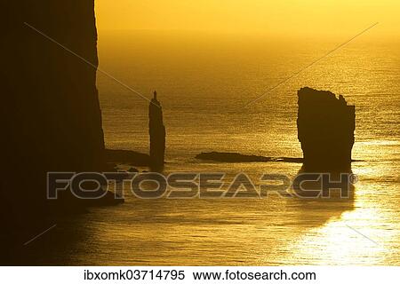 "Kellingin and Risin sea stacks, petrified trolls according to legend, at sunset, Eioi, Eysturoy, Faroe Islands, Denmark, Europe" View Large Photo Image Stock Photography - "Kellingin and Risin sea stacks, petrified trolls according to legend, at sunset, Eioi, Eysturoy, Faroe Islands, Denmark, Europe". Fotosearch