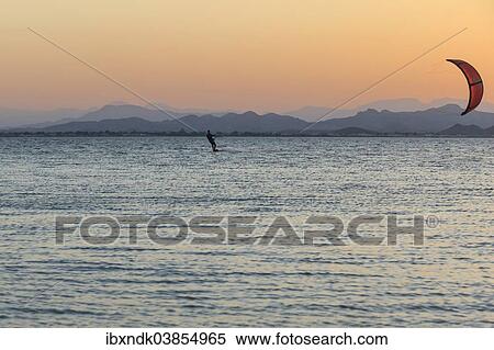 "Kitesurfer, surfing on the blue lagoon of Ras Al Hadd Lagoon in the evening light, Ras Al Hadd, Ash Sharqiyah, Oman, Asia" View Large Photo Image Stock Photography - "Kitesurfer, surfing on the blue lagoon of Ras Al Hadd Lagoon in the evening light, Ras Al Hadd, Ash Sharqiyah, Oman, Asia". Fotosearch