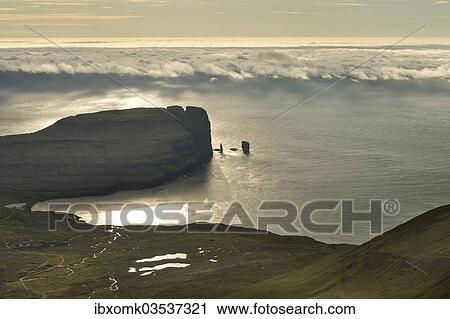 "Kollur Mountain and the sea stacks of Risin and Kellingin in the evening light, Eioi, Eysturoy, Faroe Islands, Denmark, Europe" View Large Photo Image Stock Image - "Kollur Mountain and the sea stacks of Risin and Kellingin in the evening light, Eioi, Eysturoy, Faroe Islands, Denmark, Europe". Fotosearch
