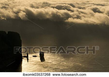 "Kollur Mountain and the sea stacks of Risin and Kellingin in the evening light, Eioi, Eysturoy, Faroe Islands, Denmark, Europe" View Large Photo Image Stock Photo - "Kollur Mountain and the sea stacks of Risin and Kellingin in the evening light, Eioi, Eysturoy, Faroe Islands, Denmark, Europe". Fotosearch