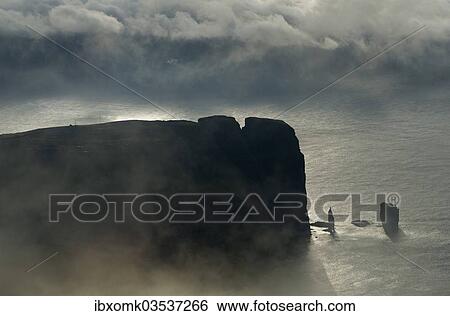 "Kollur Mountain and the sea stacks of Risin and Kellingin in the evening light, Eioi, Eysturoy, Faroe Islands, Denmark, Europe" View Large Photo Image Stock Photograph - "Kollur Mountain and the sea stacks of Risin and Kellingin in the evening light, Eioi, Eysturoy, Faroe Islands, Denmark, Europe". Fotosearch