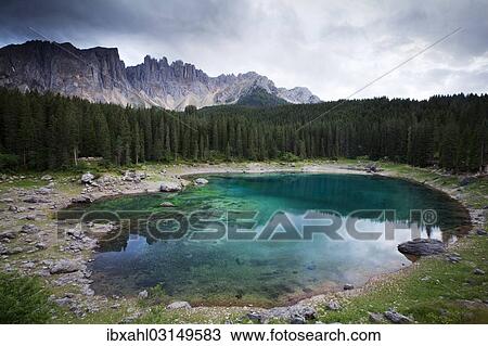 "Lake Carezza with Latemar Mountain with clouds, Karerpass, Dolomiten, South Tyrol province, Trentino-Alto Adige, Italy, Europe" View Large Photo Image Stock Image - "Lake Carezza with Latemar Mountain with clouds, Karerpass, Dolomiten, South Tyrol province, Trentino-Alto Adige, Italy, Europe". Fotosearch