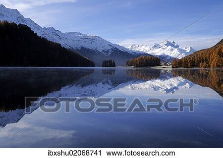 Stock Image - "Lake Champfer with larch forest with autumnal colouring, Mt Piz da la Margna at back, St. Moritz, Engadine, Grisons, Switzerland, Europe". Fotosearch