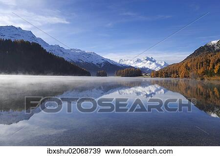 Stock Photo - "Lake Champfer with larch forest with autumnal colouring, Mt Piz da la Margna at back, St. Moritz, Engadine, Grisons, Switzerland, Europe". Fotosearch
