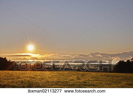 "Lake Chiemsee as seen from Ratzinger Hoehe at sunrise, Chiemgau, Upper Bavaria, Bavaria, Germany, Europe" View Large Photo Image Stock Photo - "Lake Chiemsee as seen from Ratzinger Hoehe at sunrise, Chiemgau, Upper Bavaria, Bavaria, Germany, Europe". Fotosearch