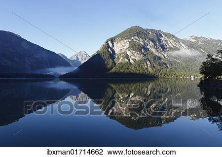 Stock Image - "Lake Plansee, Ammergau Alps, Ammergebirge mountains, in the back Mt. Thaneller in the Lechtal Alps, Tyrol, Austria, Europe". Fotosearch