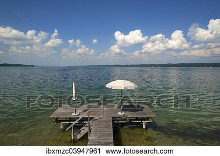 "Lake Starnberg with bathing jetty and parasol, Seeshaupt, Upper Bavaria, Bavaria, Germany, Europe" View Large Photo Image Stock Image - "Lake Starnberg with bathing jetty and parasol, Seeshaupt, Upper Bavaria, Bavaria, Germany, Europe". Fotosearch