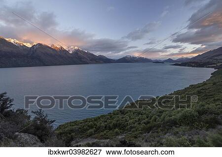 "Lake Wakatipu at sunrise, Otago Region, South Island, New Zealand, Oceania" View Large Photo Image Stock Photo - "Lake Wakatipu at sunrise, Otago Region, South Island, New Zealand, Oceania". Fotosearch