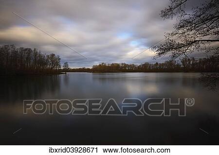 "Lake with trees and a cloudy sky, Alpen, Lower Rhine, Germany, Europe" View Large Photo Image Stock Image - "Lake with trees and a cloudy sky, Alpen, Lower Rhine, Germany, Europe". Fotosearch
