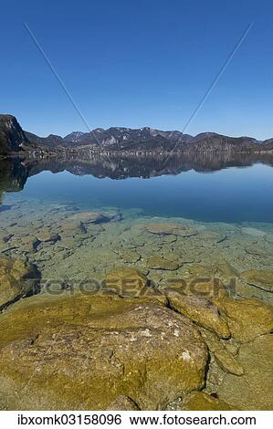 Stock Photograph - "Lake Wolfgang with a reflection of the surrounding mountains, near St. Gilgen, Salzkammergut, Salzburger Land, Oberosterreich, Austria, Europe". Fotosearch