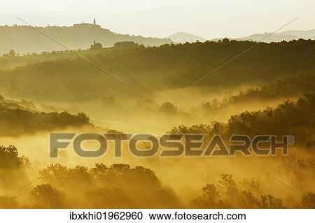 Stock Image - "Landscape in the morning fog, San Quirico, Val d'Orcia, Tuscany, Italy, Europe". Fotosearch
