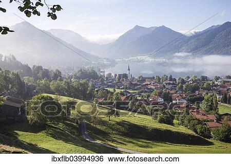 Stock Photograph - "Landscape with townscape, morning mist, Schliersee, Upper Bavaria, Bavaria, Germany, Europe". Fotosearch