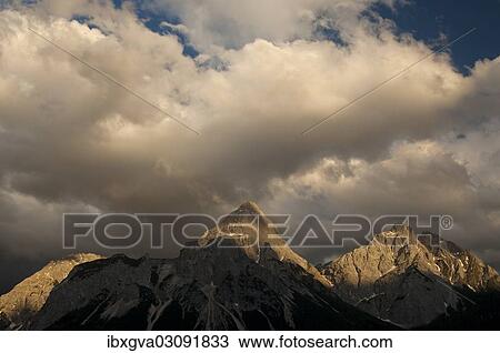 "Last sunlight shining on the peaks of the Mieming Range with the mountains Ehrwalder Sonnenspitze and Gruenstein, Ehrwald, Tyrol, Austria, Europe" View Large Photo Image Stock Image - "Last sunlight shining on the peaks of the Mieming Range with the mountains Ehrwalder Sonnenspitze and Gruenstein, Ehrwald, Tyrol, Austria, Europe". Fotosearch