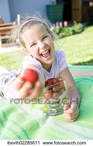 Laughing girl with strawberries in the garden View Large Photo Image Stock Image - Laughing girl with strawberries in the garden. Fotosearch