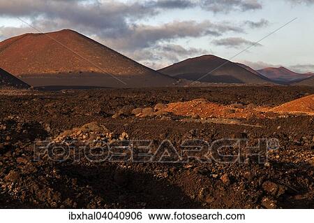 Stock Photograph - "Lava field, Fire Mountains, volcanoes, volcanic landscape, evening light, Timanfaya National Park, Lanzarote, Canary Islands, Spain, Europe". Fotosearch