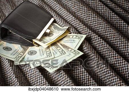 Stock Image - Leather coin purse on a plaited tweed skirt with money strewn around. Fotosearch