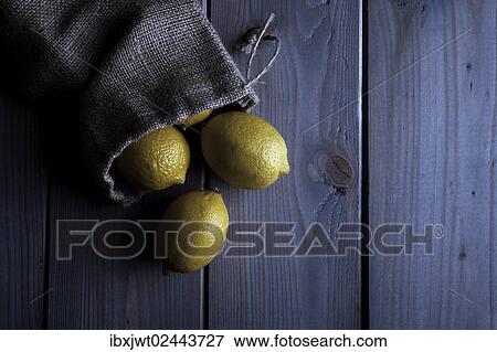 Lemons in a jute sack on wooden boards View Large Photo Image Stock Photo - Lemons in a jute sack on wooden boards. Fotosearch