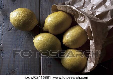 Lemons with a paper bag on a wooden background View Large Photo Image Stock Image - Lemons with a paper bag on a wooden background. Fotosearch