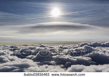 Stock Image - "Lenticular cloud, Cumulus lenticularis, above the top layer of clouds, North Rhine-Westphalia, Germany, Europe". Fotosearch