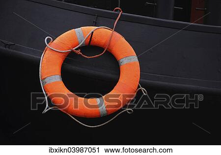 Stock Image - "Lifebuoy on ship black wall, Rostock, Mecklenburg-Western Pomerania, Germany, Europe". Fotosearch