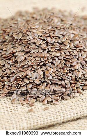 Stock Image - Linseeds on burlap sack. Fotosearch