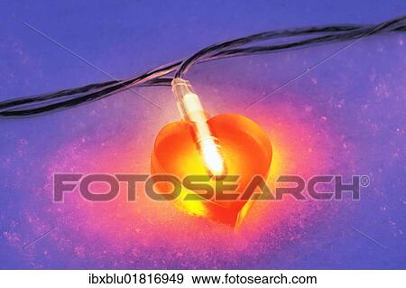 Lit heart-shaped fairy lights in the snow View Large Photo Image Stock Photo - Lit heart-shaped fairy lights in the snow. Fotosearch
