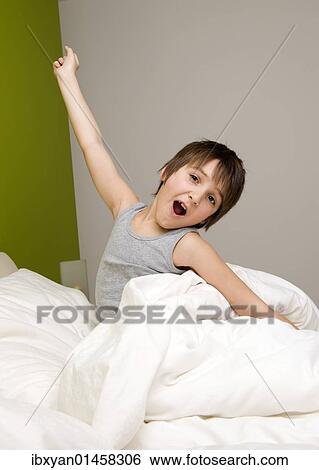 Little boy waking up in the morning View Large Photo Image Stock Photograph - Little boy waking up in the morning. Fotosearch