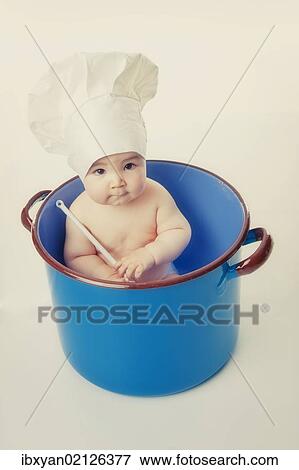 "Little child wearing chef's hat, in a cooking pot" View Large Photo Image Stock Photo - "Little child wearing chef's hat, in a cooking pot". Fotosearch