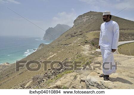 "Local man wearing a white dishdash, near Mughsayl, Dhofar Region, Orient, Oman, Asia" View Large Photo Image Picture - "Local man wearing a white dishdash, near Mughsayl, Dhofar Region, Orient, Oman, Asia". Fotosearch