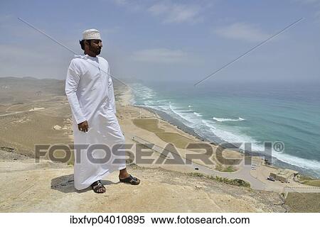 "Local man wearing a white dishdash, near Mughsayl, Dhofar Region, Orient, Oman, Asia" View Large Photo Image Stock Photography - "Local man wearing a white dishdash, near Mughsayl, Dhofar Region, Orient, Oman, Asia". Fotosearch
