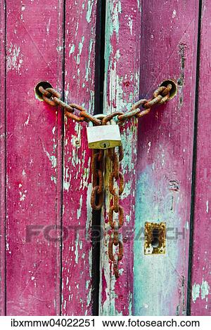 Stock Image - "Lock on a chain, wood door". Fotosearch