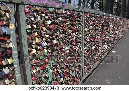 Stock Image - "Locks as a proof of love, Rheinbruecke bridge across the Rhine river, Cologne, North Rhine-Westphalia, Germany, Europe". Fotosearch