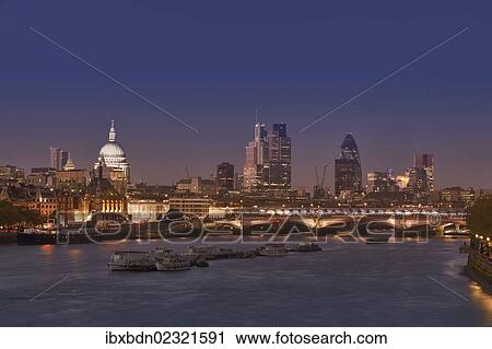 Stock Image - "London skyline and river Thames at dusk, London, England, United Kingdom, Europe". Fotosearch