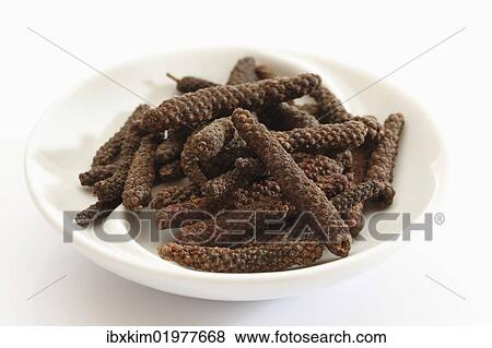 Stock Photo - Long pepper in a small porcelain bowl. Fotosearch