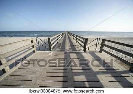 "Long wooden pier, beach, blue sky and blue sea, Boltenhagen, Mecklenburg-Western Pomerania, Germany, Europe" View Large Photo Image Stock Photography - "Long wooden pier, beach, blue sky and blue sea, Boltenhagen, Mecklenburg-Western Pomerania, Germany, Europe". Fotosearch