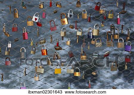 Stock Image - "Love locks, padlocks, as a sign of live, at the main bridge over the Mur river, Graz, Styria, Austria, Europe". Fotosearch