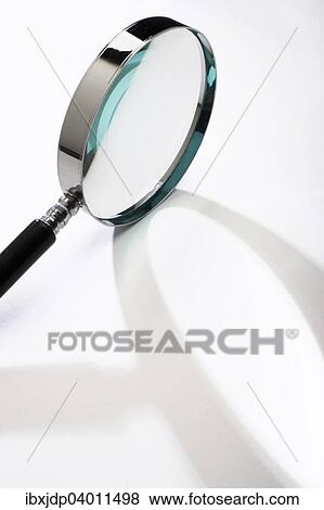 Stock Photo - Magnifying glass casting a shadow. Fotosearch