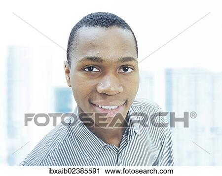 "Man, businessman, young, African-American, American, friendly, smiling, confident, successful, in front of a city skyline" View Large Photo Image Stock Image - "Man, businessman, young, African-American, American, friendly, smiling, confident, successful, in front of a city skyline". Fotosearch