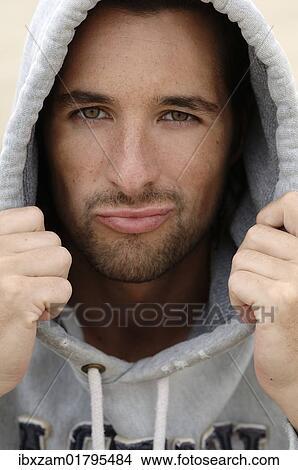 "Man, early 30s, wearing a hooded sweater in bad weather at the beach, portrait" View Large Photo Image Picture - "Man, early 30s, wearing a hooded sweater in bad weather at the beach, portrait". Fotosearch