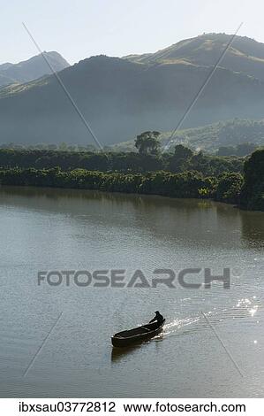 "Man in a rowing boat, dug out canoe on a river in the morning, near Fort-Dauphin or Tolagnaro, Madagascar, Africa" View Large Photo Image Stock Image - "Man in a rowing boat, dug out canoe on a river in the morning, near Fort-Dauphin or Tolagnaro, Madagascar, Africa". Fotosearch