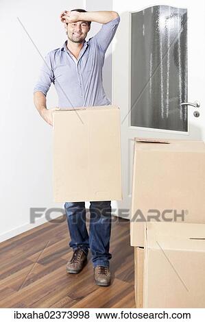 Man moving house View Large Photo Image Stock Photo - Man moving house. Fotosearch