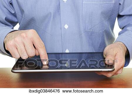 Man using a tablet computer View Large Photo Image Stock Photograph - Man using a tablet computer. Fotosearch
