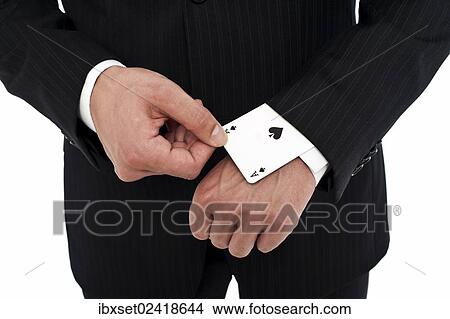 Picture - Man wearing a suit pulling an ace of spades out of his sleeve. Fotosearch