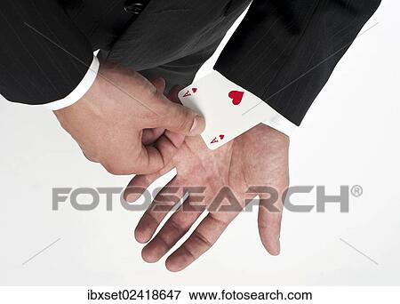 Man wearing a suit pulling an ace of hearts out of his sleeve View Large Photo Image Stock Photo - Man wearing a suit pulling an ace of hearts out of his sleeve. Fotosearch