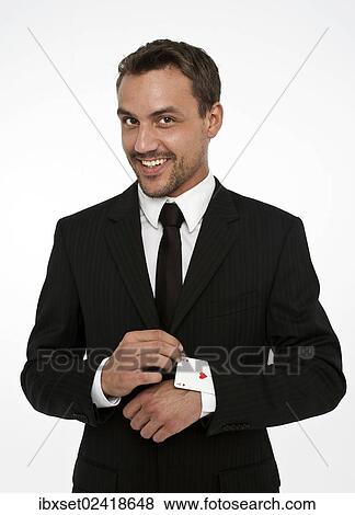 Man wearing a suit pulling an ace of hearts out of his sleeve View Large Photo Image Stock Photo - Man wearing a suit pulling an ace of hearts out of his sleeve. Fotosearch