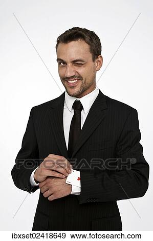 Man wearing a suit pulling an ace of hearts out of his sleeve View Large Photo Image Stock Photo - Man wearing a suit pulling an ace of hearts out of his sleeve. Fotosearch