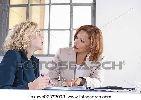 Manager working in an office with a trainee View Large Photo Image Stock Image - Manager working in an office with a trainee. Fotosearch