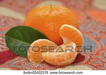 Mandarine and pieces of mandarine View Large Photo Image Stock Photo - Mandarine and pieces of mandarine. Fotosearch